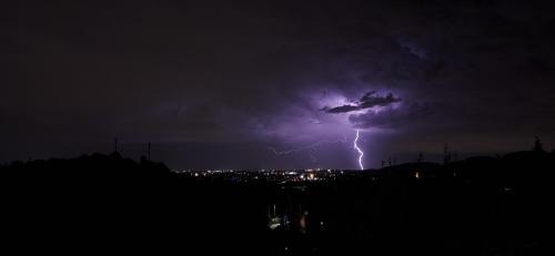 a lightning storm in the sky over a city at Villa Duno a un passo da Città Alta in Clanezzo