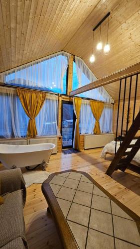 a bathroom with a tub and a staircase in a room at mood villa kazbegi in Kazbegi