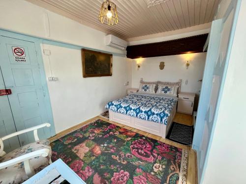 a small bedroom with a bed and a rug at Mystic Konak in Selcuk