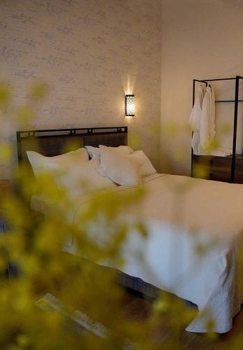 a bedroom with a large bed with pillows at Le prince Rooms in Tirana