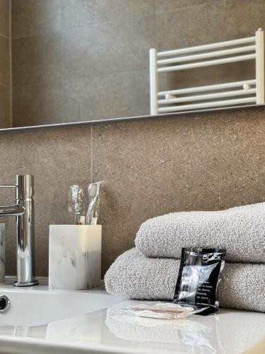 a bathroom with a sink and towels on a counter at Loft Luna Brussels Midi in Brussels