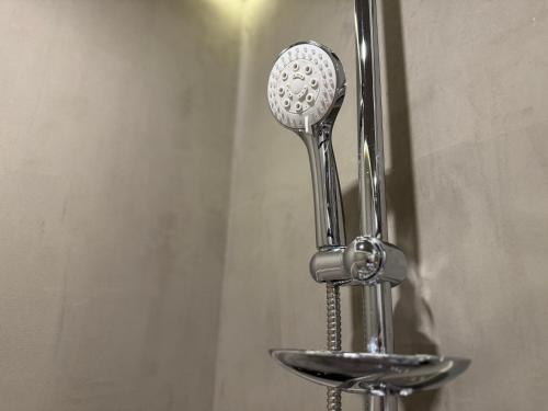 a metal toothbrush holder on a wall at 1-BR Luxury Condo, Centrio Tower, Ayala Malls in Cagayan de Oro