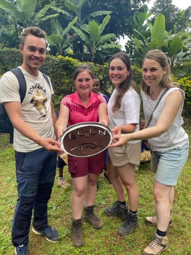 a group of people holding up a cake at Shimbwe Meadows Home in Moshi