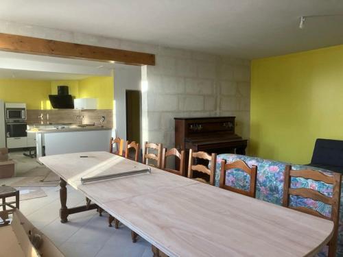 une salle à manger avec une longue table et des chaises dans l'établissement maison de campagne, à Saint-Léger