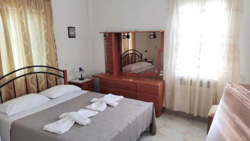 a bedroom with two beds and a large mirror at Family House , Amazing Sea View in Kamarai