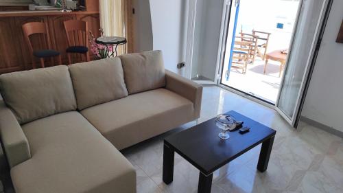 a living room with a couch and a table at Family House , Amazing Sea View in Kamarai