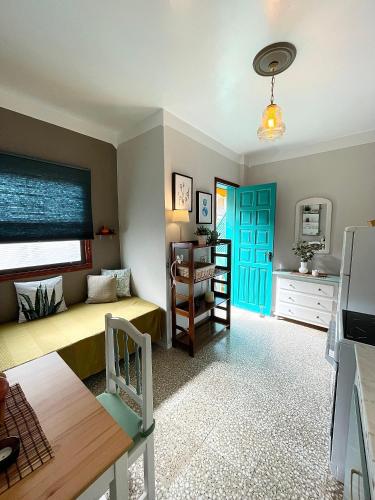 a living room with a couch and a blue door at Apartamentos San Jose in Valle Gran Rey