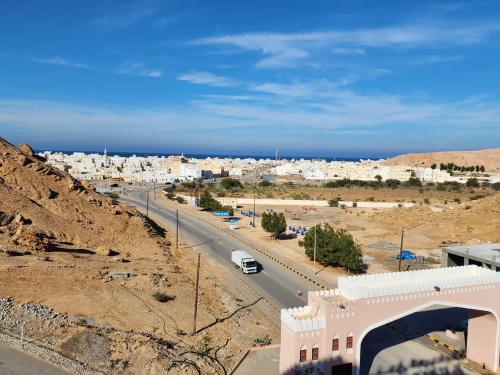 a view of a city with a road and buildings at Al Ayjah Plaza Hotel in Sur