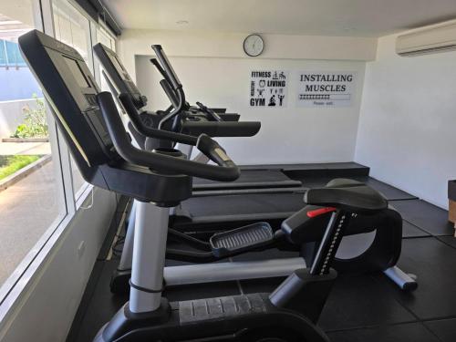 a gym with several exercise bikes in a room at The beach front Condo in Ban Saiyuan (1)