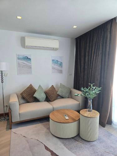 a living room with a couch and a table at The beach front Condo in Ban Saiyuan (1)