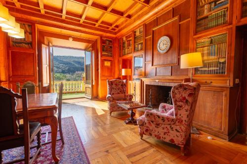 a living room with a fireplace and a table and chairs at Els Jardins De La Martana in Besalú
