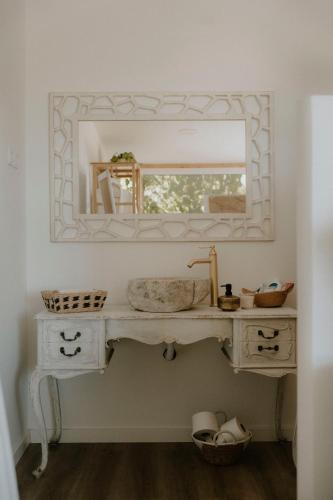 a bathroom with a sink and a mirror at Casa Castilho in Casais