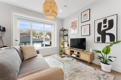 a living room with a couch and a tv at Charming 3BR Home in a Lovely Vancouver Neighborhood in Vancouver