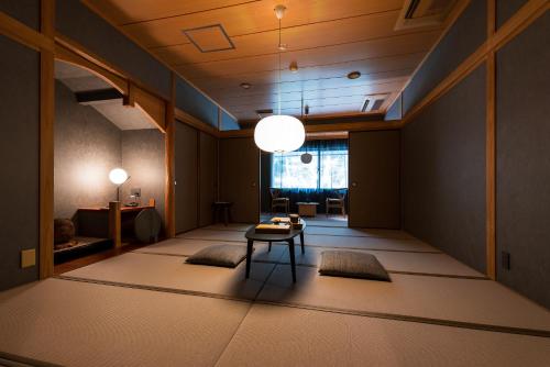 a hallway with a table and chairs in a room at くらま温泉 in Kyoto