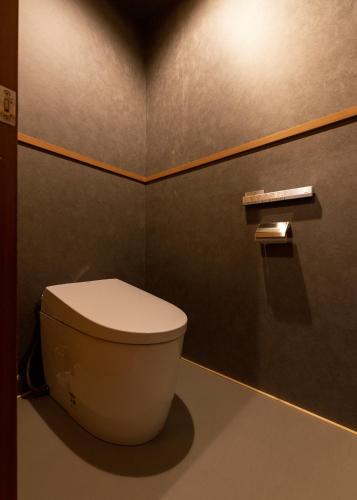 a bathroom with a white toilet in a room at くらま温泉 in Kyoto
