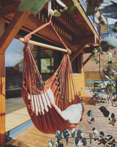 a hammock hanging from a porch of a house at L'abri de Saint-Germain, between lake and mountains in Talloires