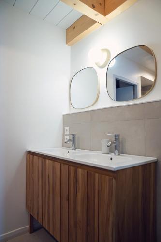 a bathroom with a sink and a mirror at L'abri de Saint-Germain, between lake and mountains in Talloires