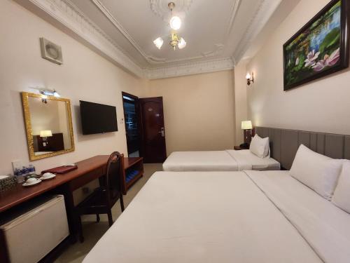 Postel nebo postele na pokoji v ubytování Bon Ami Hotel - Thiên Xuân Hotel