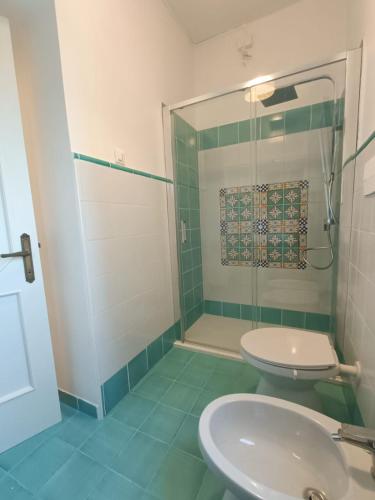 a bathroom with a shower and a toilet and a sink at casale nonna Elisa relax tra ulivi in San Vito Chietino