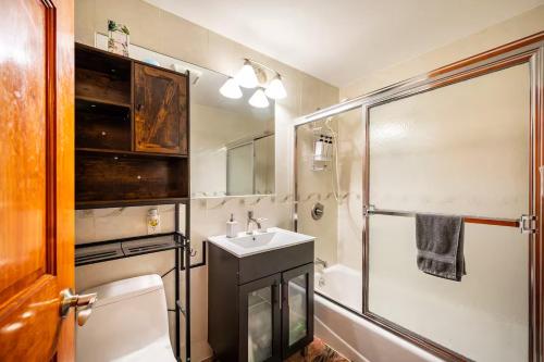 a bathroom with a toilet and a sink and a shower at BEST Large Private Room & Private Bathroom in Queens