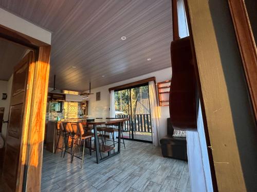 a dining room and kitchen with a table and chairs at Athila Ecolove in Monteverde Costa Rica