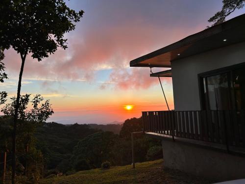a house with a view of the sunset at Athila Ecolove in Monteverde Costa Rica