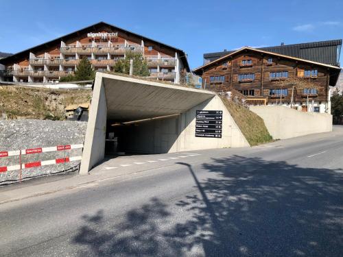 a tunnel on the side of a road with a building at Rancho Laaxdeluxe in Laax