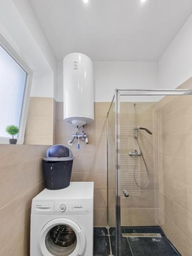a bathroom with a washing machine and a shower at Sparkassa Stockerau in Stockerau