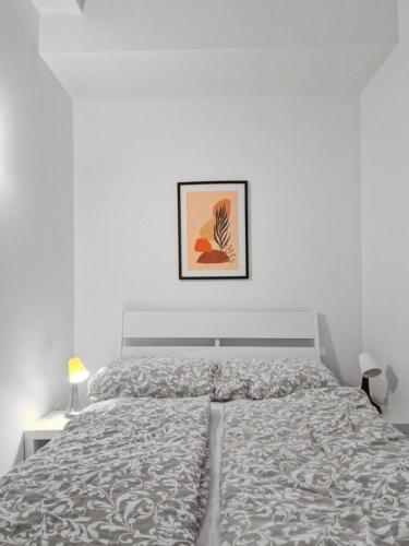 a bedroom with a bed and a picture on the wall at Sparkassa Stockerau in Stockerau
