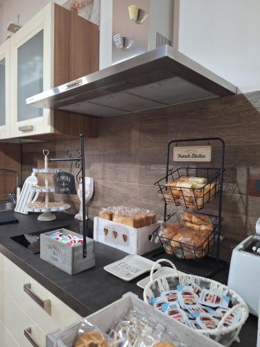 a kitchen with a counter with baskets of bread at B&B La Locanda del Sorriso in Orte