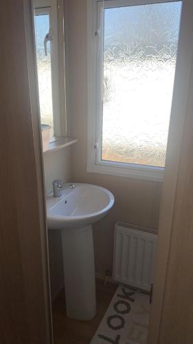 a bathroom with a sink and a window at Riverside 35 - Haggerston Castle in Beal