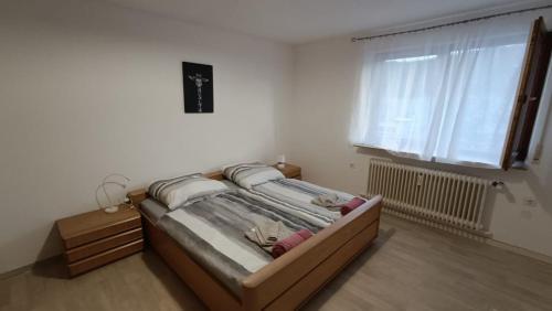 a bed in a room with a large window at Apartment Linda in Tuttlingen