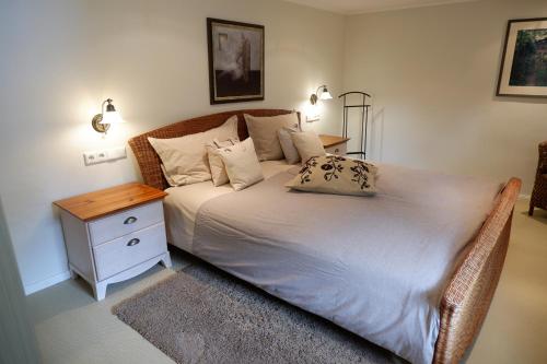 a bedroom with a large bed with a nightstand and a bed sidx sidx sidx at Fachwerkliebe Baudenkmal Ornes in Olsberg