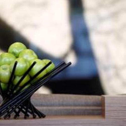 a bunch of green apples in a black basket at Hyatt Place Houston- Northwest/Cy-Fair in Houston