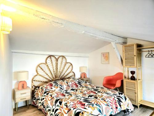 a bedroom with a large bed and a red chair at Au coeur du Capitole - calme - metro in Toulouse