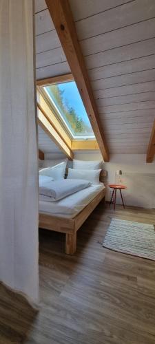 a bed in a room with a window at Ferienwohnung am Bach in Bischofswiesen