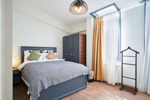 a bedroom with a large bed and a window at Modern Furnished Historical Building in Istanbul
