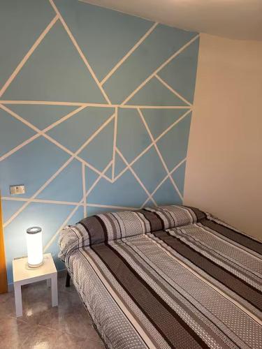 a bedroom with a bed with a geometric wall at Home Belvedere in Belvedere Marittimo