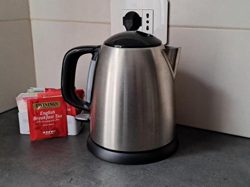 a stainless steel tea kettle sitting on a counter at Suite Panoramica in Novara