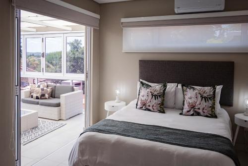 a bedroom with a bed and a living room at Dulce Vita Self-Catering Duet in Bloemfontein