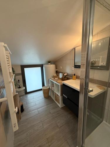 a large bathroom with a sink and a refrigerator at Escale au Calme in Le Pouzin