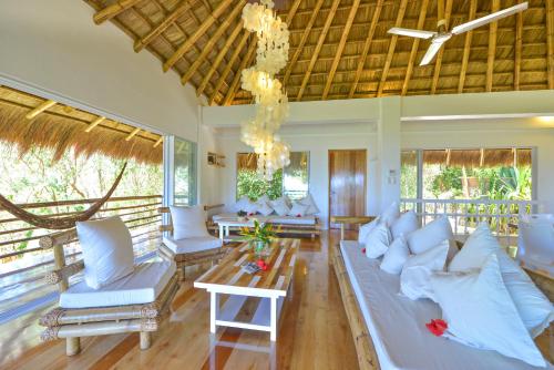 a living room with white furniture and large windows at Diniview Villa Resort in Boracay