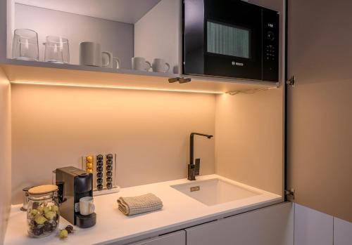 a kitchen with a counter with a microwave above a sink at Studio Palace Gates in Split