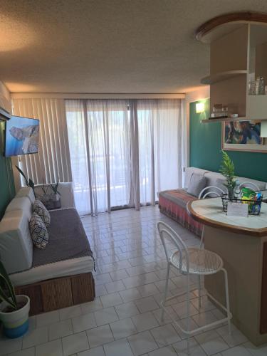 a living room with a couch and a table at Apartamento Terrazas de Guacuco in Las Piedras