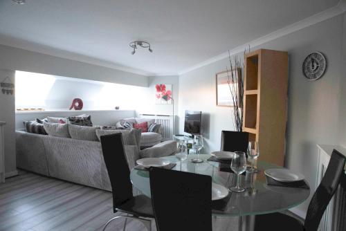 a living room with a table and a couch at The Stables - Fabulous stylish flat in Merchant City & Free Secure Parking in Glasgow