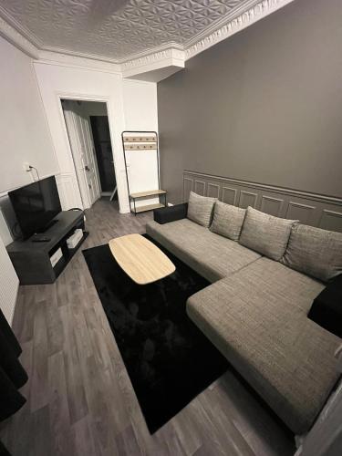 un salon avec un canapé et une table dans l'établissement COZY apartment close to Paris, à Saint-Ouen