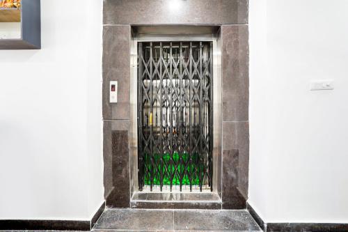 a door with a metal gate in a building at Hotel O LAHARI LUXURY ROOMS in Warangal