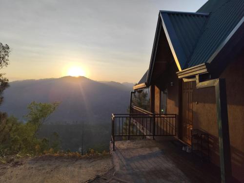 a house with a balcony with the sunset in the background at Miracle view Ella in Ella