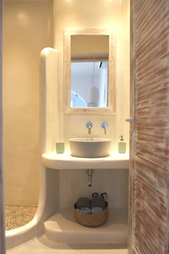 a bathroom with a sink and a mirror at Sandora in Agios Prokopios