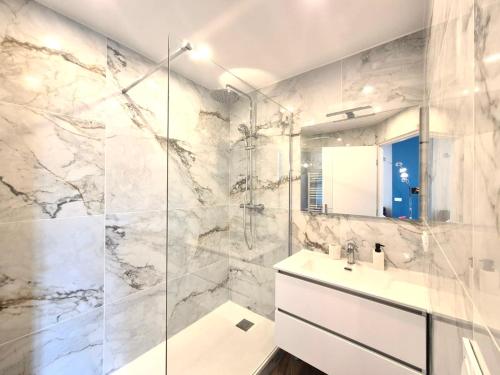a white bathroom with a sink and a shower at Luxury 3 bed 2 bath flat Cannes Croisette in Cannes